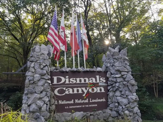 Sign welcoming visitors to Dismal's Canyon in Phil Campbell, Alabama