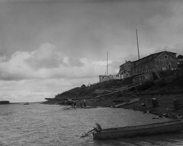 Yukon River at Marshall Alternative Title FWS-5346 U.S. FWS plane in foreground with U.S. FWS George Warner and Paul Adams. Yukon Delta National Wildlife Refuge (YUDE); FWS keywor...
