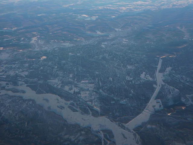 Aerial view of a section of the Tanana River Valley east of Fairbanks. The Tanana River itself is in the bottom left corner; North Pole, AK, is above it, in the center left. Seen...