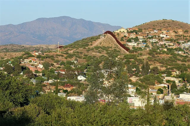 View of Nogales, Arizona/Sonora — from Arizona. The fence dividing Arizona and Mexico is visible in center of photo.