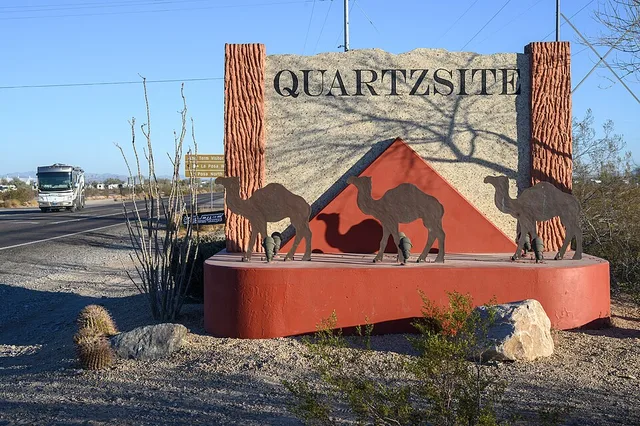 Located south of the town on Highway 95 is a sign announcing the town of Quartzsite, Arizona USA. The sign features a camel motif, alluding to the historical experimental US Camel...