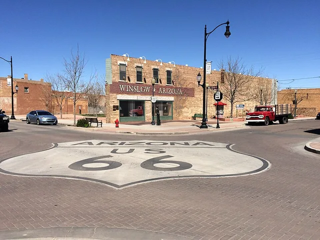Route 66 marker is painted on the road at Standing on the Corner Park, Winslow, Arizona, complete with a flat bed Ford truck