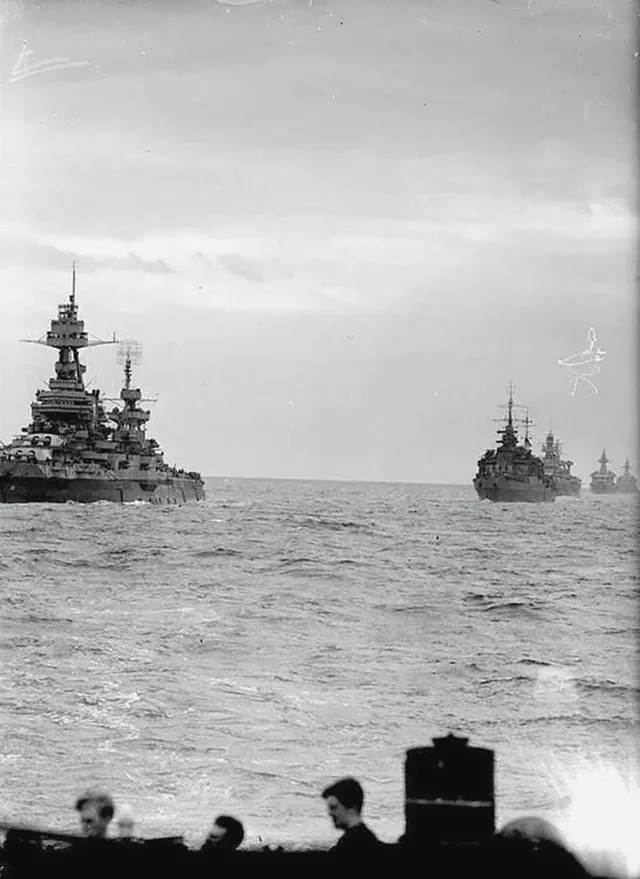 Allied warships of Bombarding Force 'O', supporting the landings in the Omaha area. The column is led by USS Texas (BB-35) (left) with HMS Glasgow, USS Arkansas (BB-33), FFS Georg...