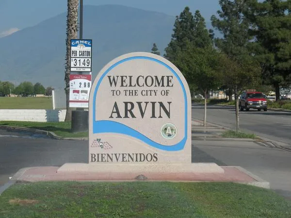 "Welcome to the city of Arvin." Sign in a convenience store parking lot at the entrance to Arvin, California.