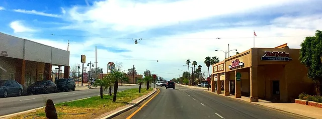 Downtown Calipatria, California at East Main Street ( CA SR 115 ) and North Sorensen Avenue ( CA SR 111 ). View from the westbound lane of East Main Street, looking west. This pho...