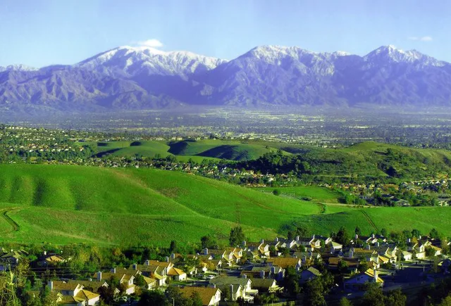 The Chino Hills (landform) and skyline of Chino Hills (city) — with the Pomona Valley beyond and the San Gabriel Mountains rising in the background. Located in San Bernardino and...