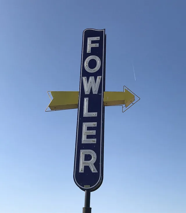 Vintage neon sign at the intersection of Golden State Blvd and E Merced St in Fowler, California.