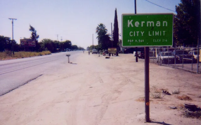 Documentary snapshot of city limit sign along SR180 on the east side of Kerman . Polaroid snapshot image taken in 2006. Photo by David Jordan. Please credit the photographer when...