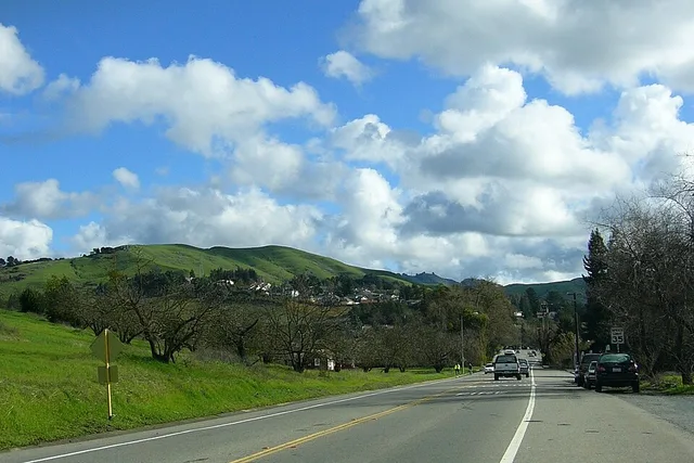 Intersection of Camino Ricardo and Moraga Way, looking east toward Moraga Road. The fire station is on the right and the old pear orchard is on the left.