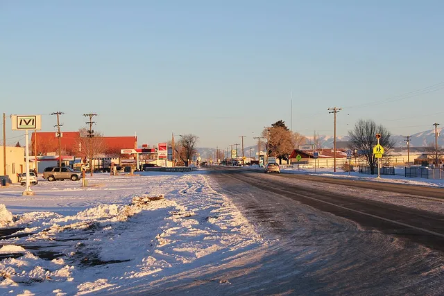 A view of the town of Center, Colorado. The road in the picture is Colorado State Highway 112, which also marks the border between Saguache County, on the left (north), and Rio Gr...