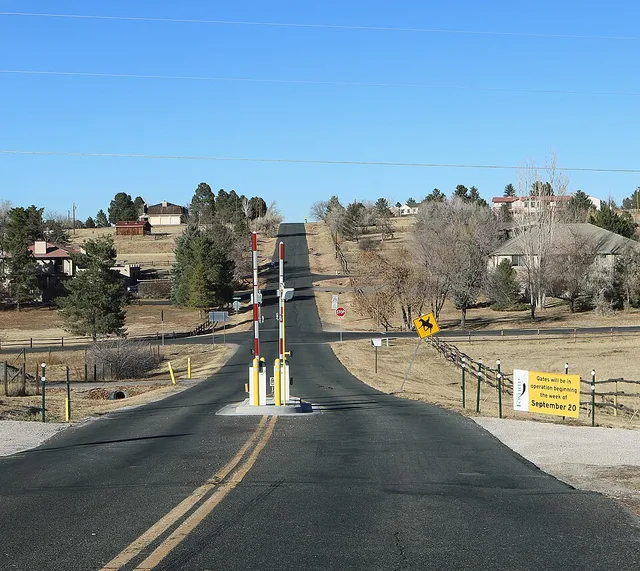 Looking north along South Richfield Street in Foxfield, Colorado . The gates here and at other places in the town were installed in 2021 and are closed twice daily during rush hou...