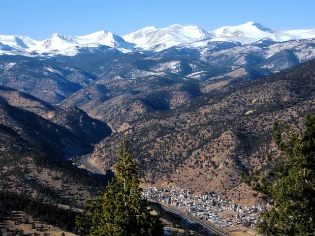 Overlooking Idaho Springs, Colorado , with the continental divide in the background, including Mt. Flora and Mt. Eva on the left and James Peak on the right.