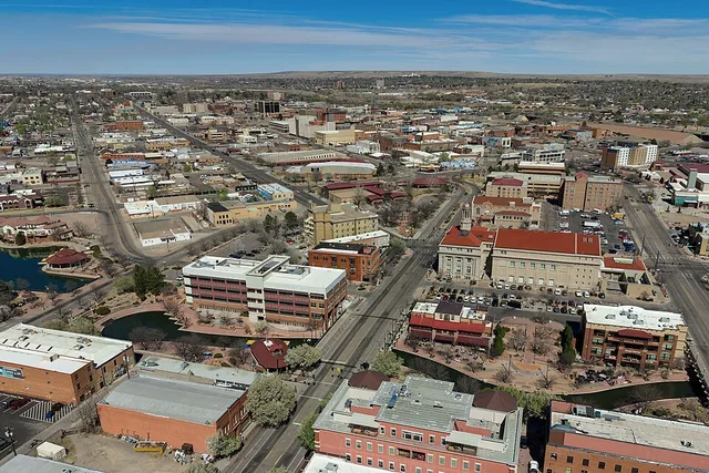 Aerial view of downtown Pueblo, Colorado (pop. 111,876), featuring the historic Arkansas Riverwalk.