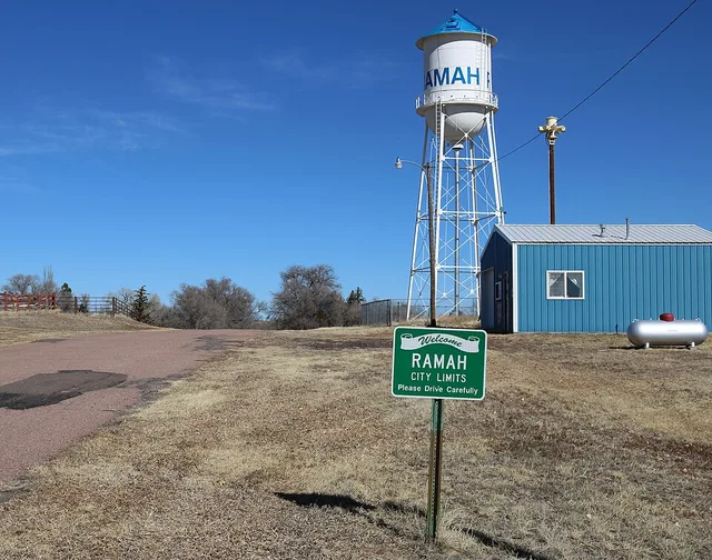 The town of Ramah, Colorado, in El Paso County. The picture shows the town water tower, its tornado warning siren, and a welcome sign. There is also a small metal building which h...