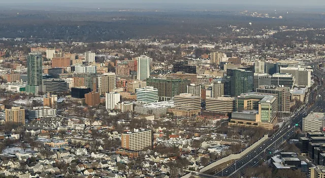 Aerial view of downtown Stamford, Connecticut, seen from the southwest in winter. Interstate 95 and the Metro-North/Amtrak rail corridor run along the east side of the city.