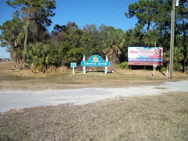 Signs welcoming northbound drivers on US 19 - 98 to the City of Crystal River, Florida . There's also a billboard for a local swimming pool business there, but that's not what thi...