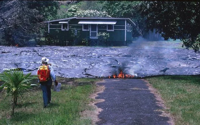 A house in Kalapana, Hawaii being destroyed by a pahoehoe flow.