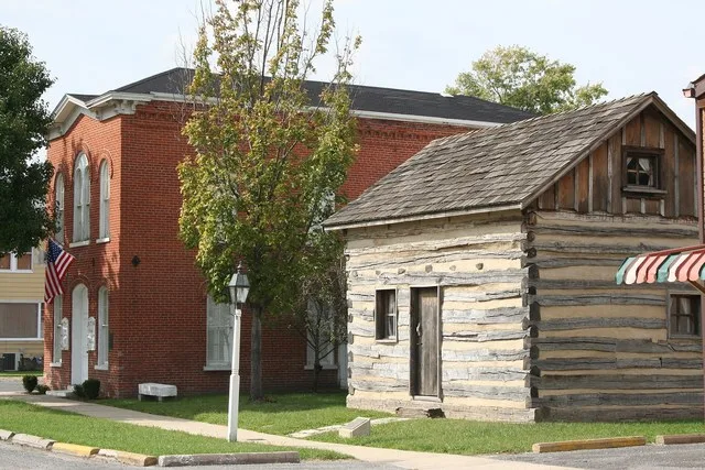 This is the old Village Hall building in Bethalto, Illinois, and a log cabin that was discovered after a house fire.