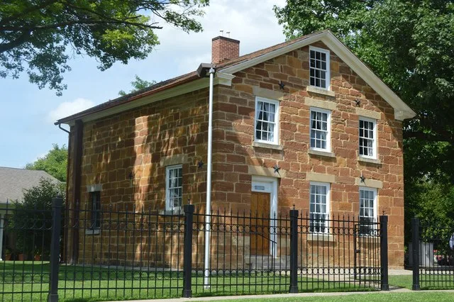 Front and western side of the Carthage Jail , located at the intersection of Walnut and Fayette Streets in Carthage , Illinois , United States . Here was killed the founder of Mor...