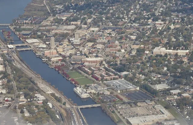 An aerial view of downtown Elgin, Illinois , a suburb of Chicago on the Fox River .