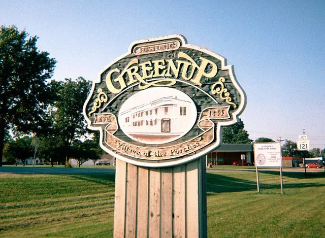 Greenup, IL city welcome sign. Photo taken in 2006, however, the sign has not changed as of 2010. Sign reads: Historic Greenup, Est. 1834, "Village of the Porches".