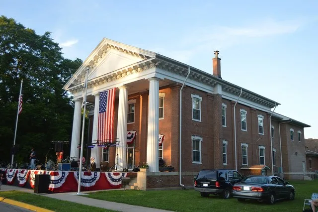 Front and southern side of the Putnam County Courthouse , located on Fourth Street facing the village park in Hennepin , Illinois , United States . Built in 1839, it is listed on...