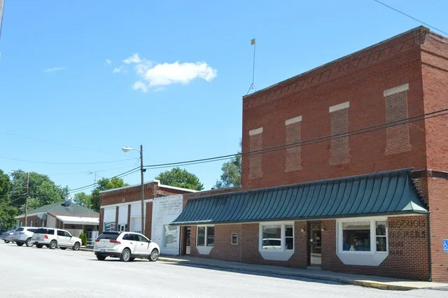 Buildings on the southern side of Lincoln Avenue just east of Hamilton Street in Iroquois , Illinois , United States .