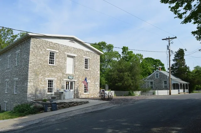 Buildings on the western side of Mill Street at the Franklin Street intersection in Maeystown , Illinois , United States . The nearer building is Zeitinger's Mill, built in 1859...