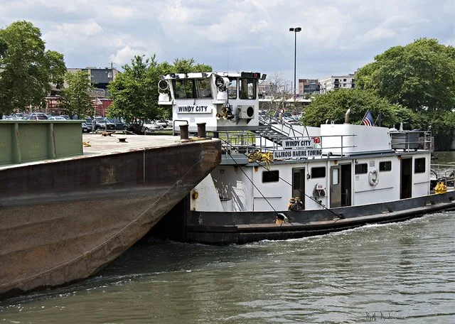 The following is the author's description of the photograph quoted directly from the photograph's Flickr page. "more like pushing than towing... North Branch, Chicago River "