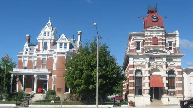 Street view of the Aaron G. Cloud House and the Cloud State Bank , located at 164 and 108 S. Washington Street in McLeansboro , Illinois , United States . Built in 1882, both are...