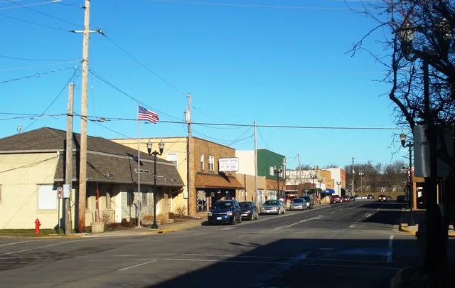 west side of 4th Street West, looking north from West 3rd Avenue, Milan, Illinois ; at left, Blackhawk Township Hall, 230-234 4th Street West