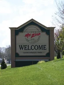 Welcome sign to Mt. Zion, IL , traveling South on Hwy. 121 .