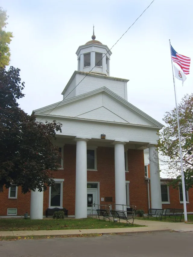 Front of the Henderson County Courthouse , located on the northwestern corner of the intersection of Fourth and Warren Streets in Oquawka , Illinois , United States . Built in 184...