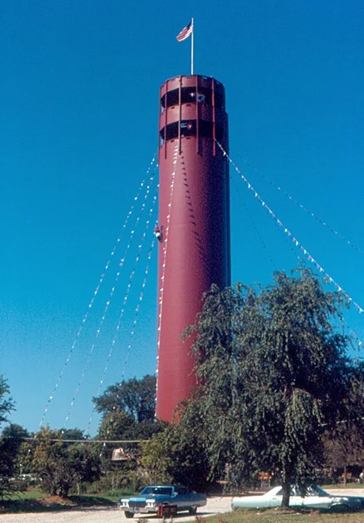 The water tower in Tower Park, Peoria Heights . It is about 200 ft (60 m) high. You can ride an elevator to the observation deck. That is a sculpture of a woodpecker a little over...