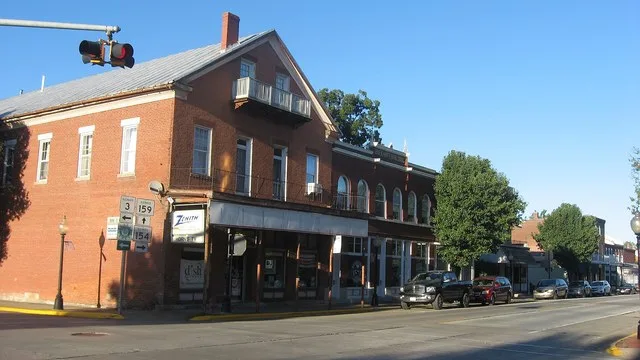 Buildings on the northern side of the 100 block of E. Market Street in downtown Red Bud , Illinois , United States . Built in 1855 (leftmost building) and unknown dates (others)...