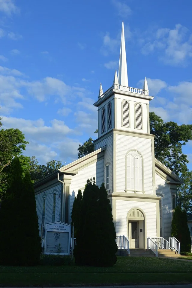Front of the Table Grove Community Church , located on the western side of Broadway ( U.S. Route 136 ) north of Liberty Street in Table Grove , Illinois , United States . Built in...