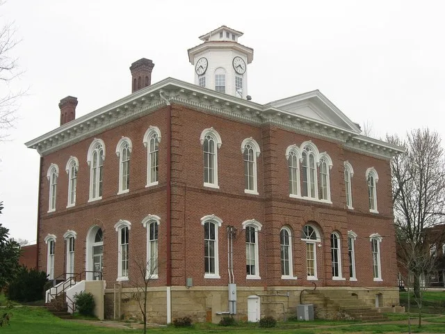 Southern and eastern sides of the Johnson County Courthouse , located on Courthouse Square in Vienna , Illinois , United States . Built in 1868, it is listed on the National Regis...