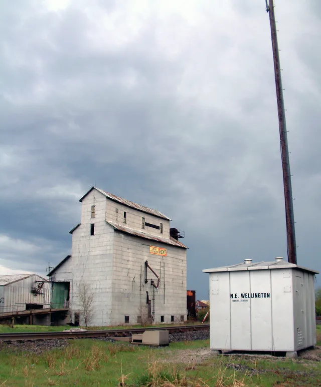 Cloudy skies over the grain elevator and CSX rail line in the village of Wellington, Illinois . Photo looks southeast from the intersection of Main Street and Prairie Street.
