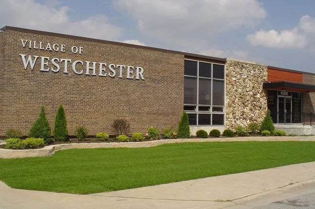 This photo depicts the front exterior of the Village Hall of Westchester, Illinois.