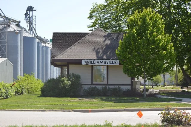 View from the north of the former train station in Williamsville , Illinois , United States , located on the southwestern corner of the junction of Main Street and the rail line.