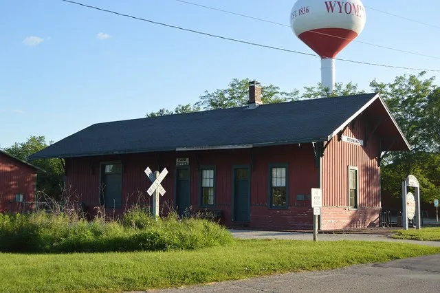 Front and northern side of the Wyoming CB&Q depot , located on the southern side of Williams Street along a rail trail in far eastern Wyoming , Illinois , United States . Built in...