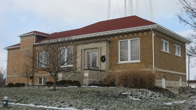Front and southern end of the Colfax Carnegie Library , located at 207 S. Clark Street in Colfax , Indiana , United States . Built in 1917, it is listed on the National Register o...