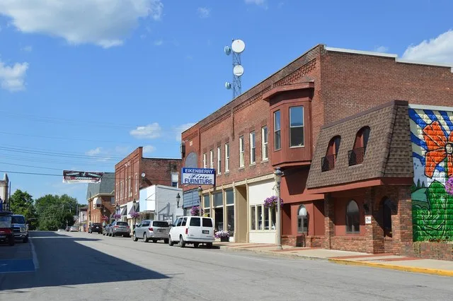 Buildings on the eastern side of Center Street, seen looking north from Columbia Street ( State Road 18 ) in downtown Flora , Indiana , United States .
