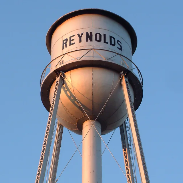 The water tower in the town of Reynolds, Indiana . This photo was taken from near the railroad tracks between Kenton Street and Clark Street, and looks generally south.