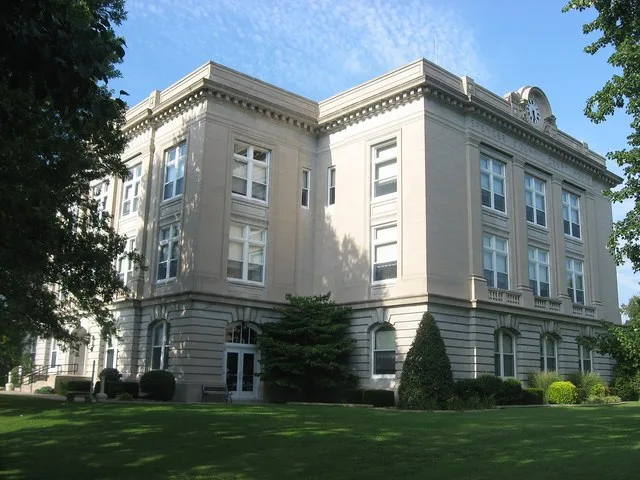Western and southern sides of the Spencer County Courthouse , located on Courthouse Square in Rockport , Indiana , United States . Built in 1921, it is listed on the National Regi...