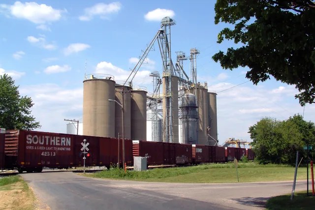 A Norfolk Southern freight train passes the grain elevators in State Line City, Indiana . This photo, taken near the corner of State Line Road and Woodard Street, looks northeast.