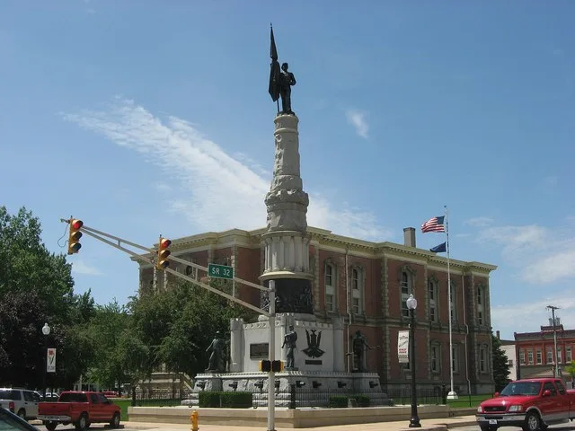 Northern side and eastern front of the Randolph County Courthouse, built in 1875 on Courthouse Square at the center of Winchester , Indiana , United States . In the foreground is...