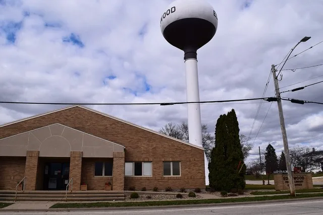 Public library and city building in Edgewood, Iowa , with the water tower behind it.