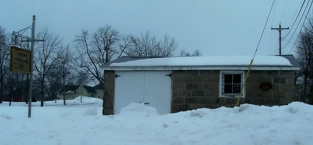 An image of the Lu Verne City Jail in Lu Verne, Iowa. The 1912 building is listed on the National Register of Historic Places.