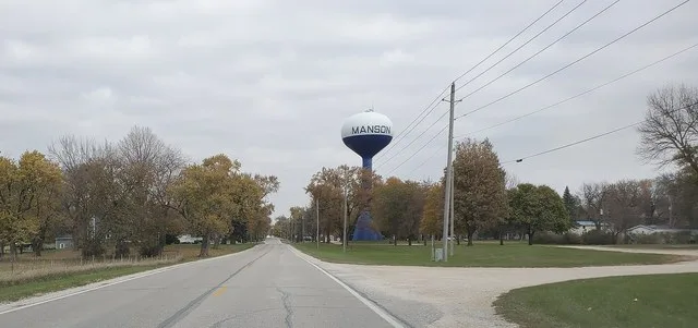 Water tower in Manson, Iowa, looking north along Tabor Avenue (8th Street). The tower is in Watertower Park.